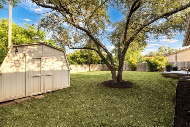 view of yard featuring a deck and a shed