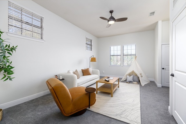 carpeted living room with ceiling fan