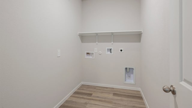 laundry area with gas dryer hookup, light hardwood / wood-style floors, hookup for a washing machine, and electric dryer hookup