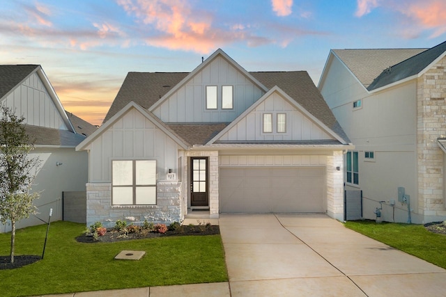 view of front of home with a garage and a lawn