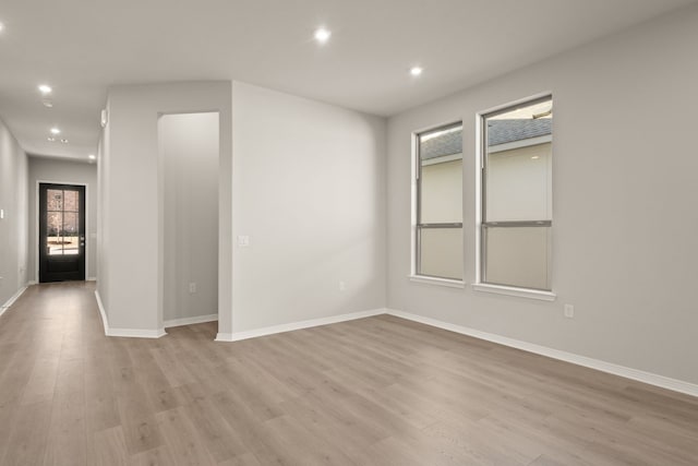 unfurnished room with light wood-type flooring