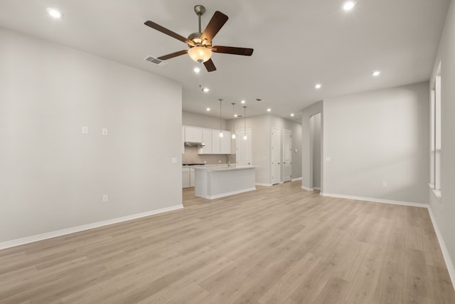 unfurnished living room featuring light hardwood / wood-style floors and ceiling fan