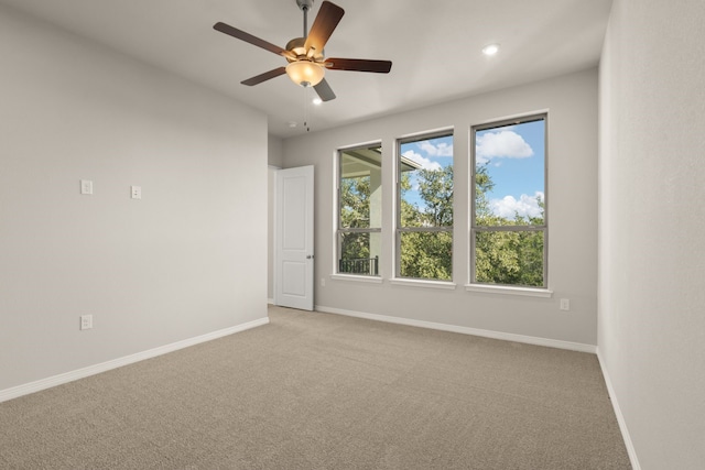 carpeted empty room featuring ceiling fan