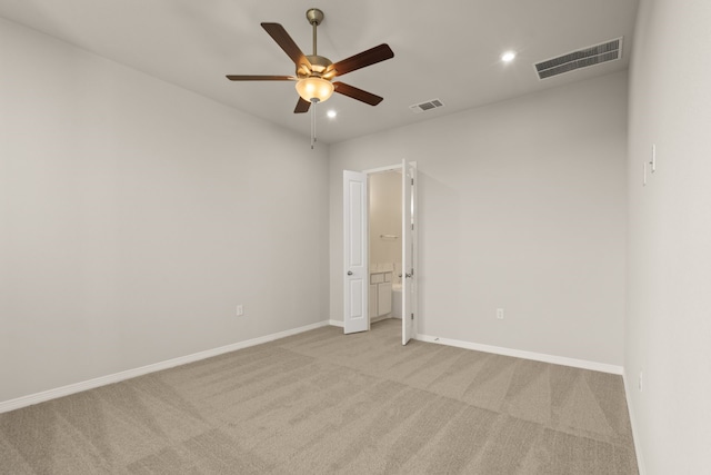 carpeted spare room with ceiling fan