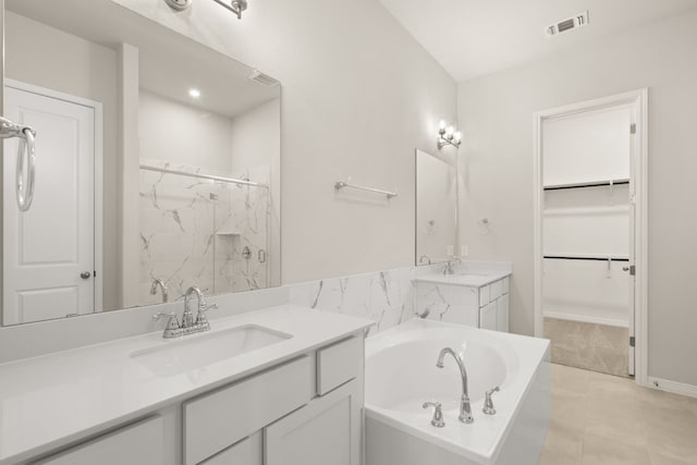 bathroom featuring tile patterned floors, vanity, and independent shower and bath