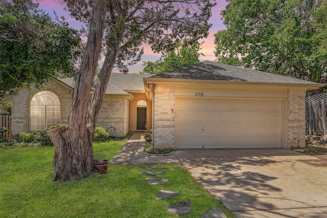 single story home with a lawn