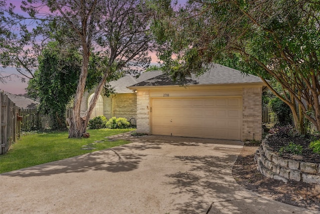 view of front of home with a lawn and a garage