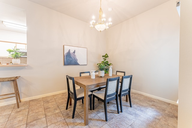 dining space with an inviting chandelier