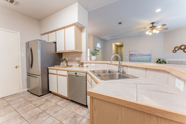 kitchen featuring backsplash, stainless steel appliances, ceiling fan, sink, and light tile patterned flooring