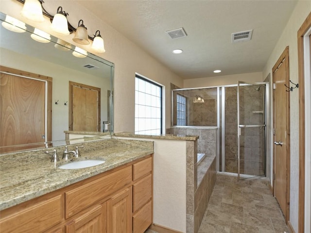 bathroom featuring plus walk in shower and vanity