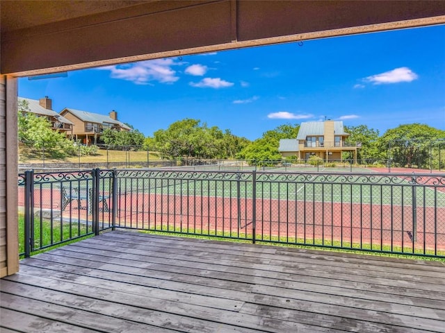 wooden deck with tennis court