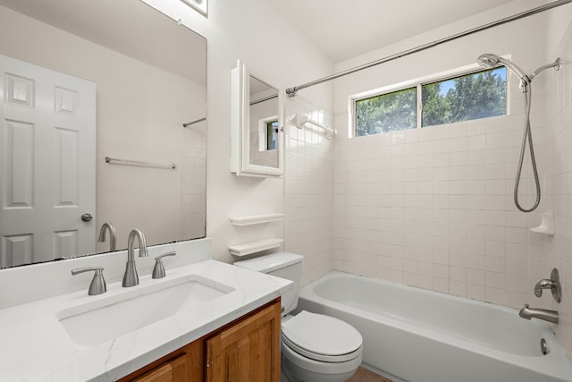 full bathroom featuring vanity, toilet, and tiled shower / bath combo