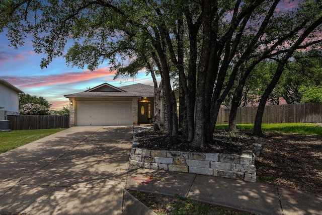 ranch-style home featuring central AC and a garage