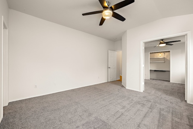 empty room with lofted ceiling, carpet floors, and ceiling fan