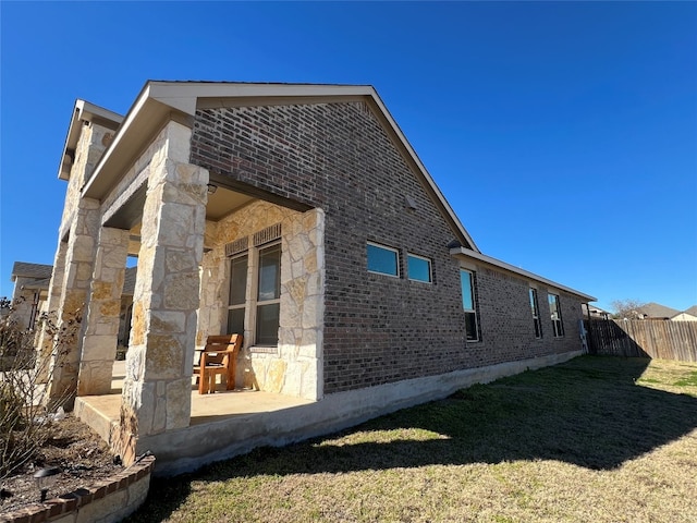 exterior space featuring a patio area and a lawn