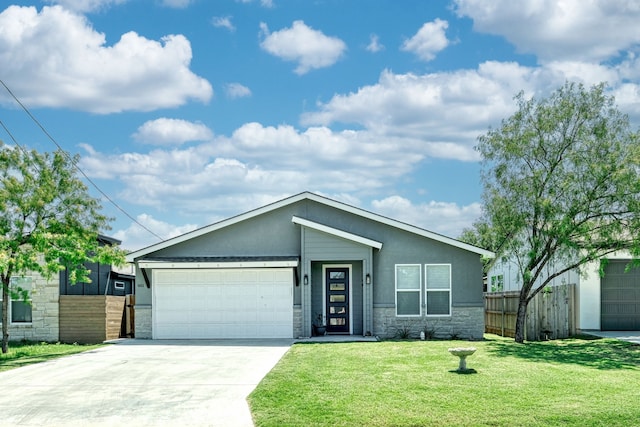 view of front of home with a front yard and a garage