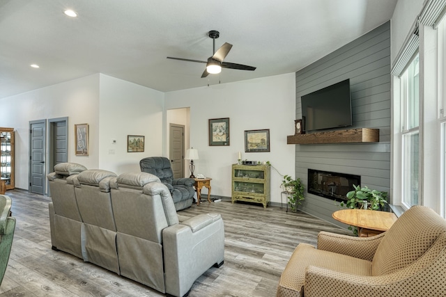 living room featuring a fireplace, a healthy amount of sunlight, and light hardwood / wood-style floors