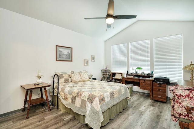 bedroom featuring ceiling fan, light hardwood / wood-style floors, and vaulted ceiling