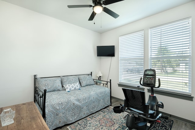 bedroom with ceiling fan and wood-type flooring