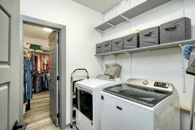 washroom featuring light wood-type flooring and washing machine and dryer