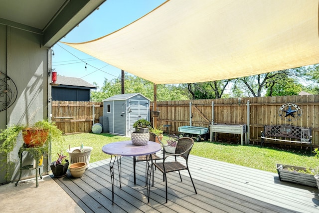 wooden deck with a shed and a lawn