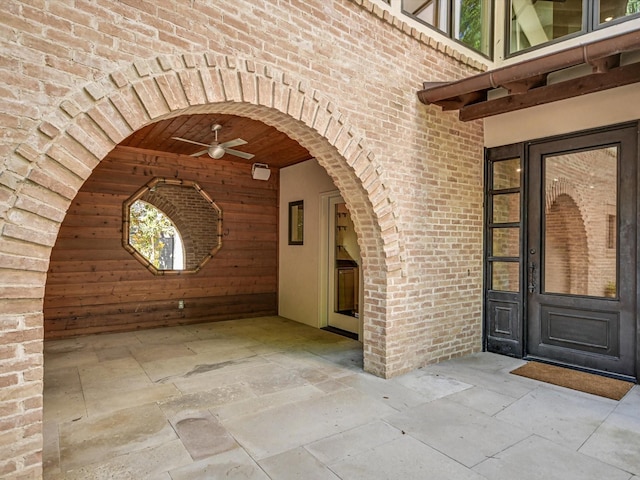 doorway to property with a patio area and ceiling fan