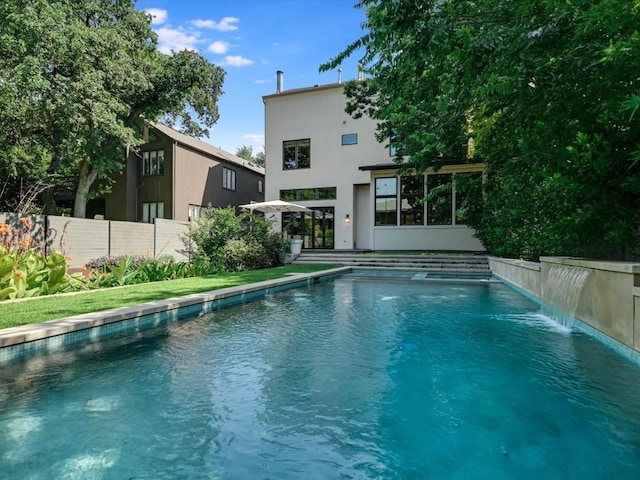 view of pool featuring a yard and pool water feature