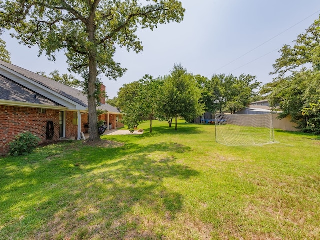 view of yard with a trampoline