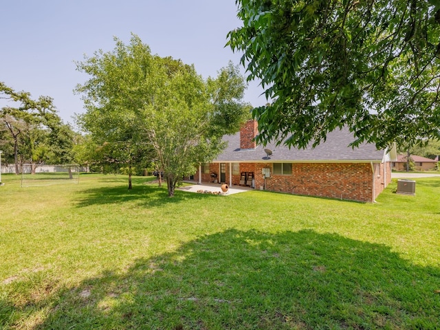 view of yard with cooling unit and a patio