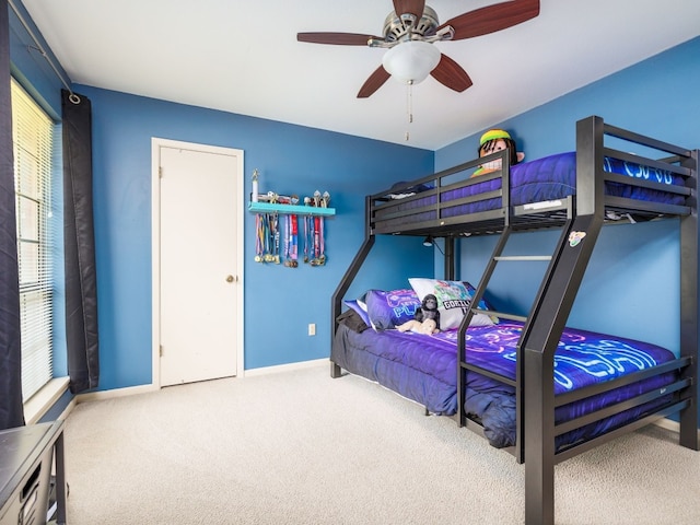 bedroom with multiple windows, carpet floors, and ceiling fan