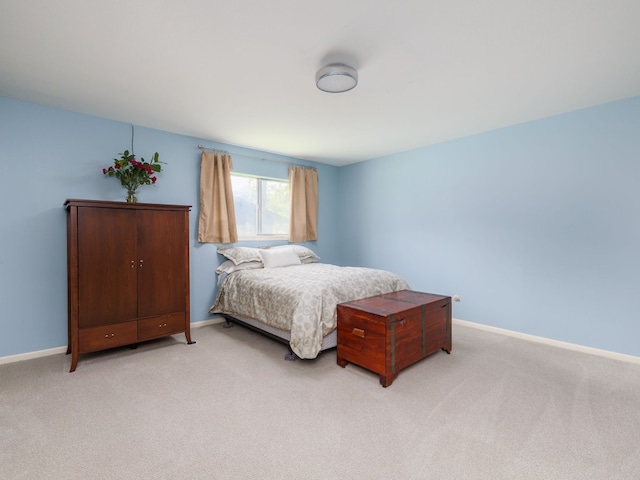 bedroom featuring light carpet