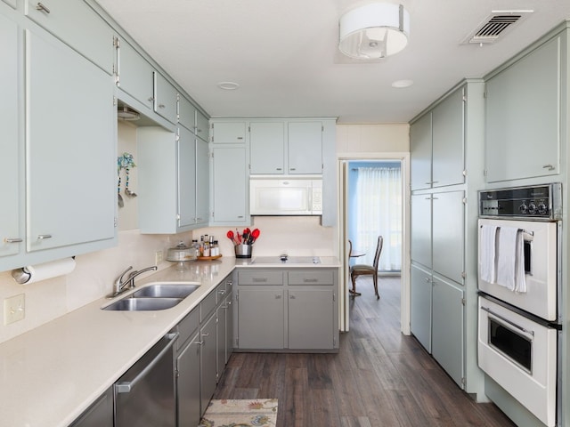 kitchen featuring dark hardwood / wood-style floors, white appliances, and sink