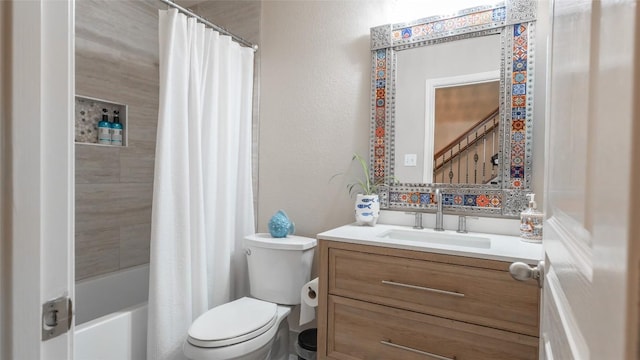 bathroom featuring toilet, a textured wall, shower / tub combo with curtain, and vanity