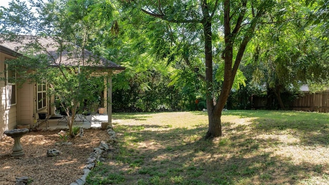 view of yard featuring a patio and fence