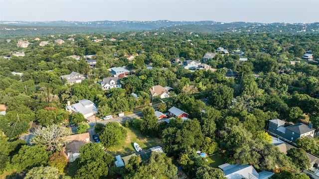 birds eye view of property featuring a wooded view