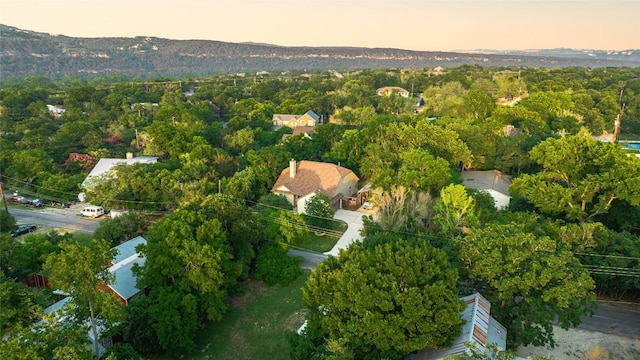 birds eye view of property featuring a view of trees