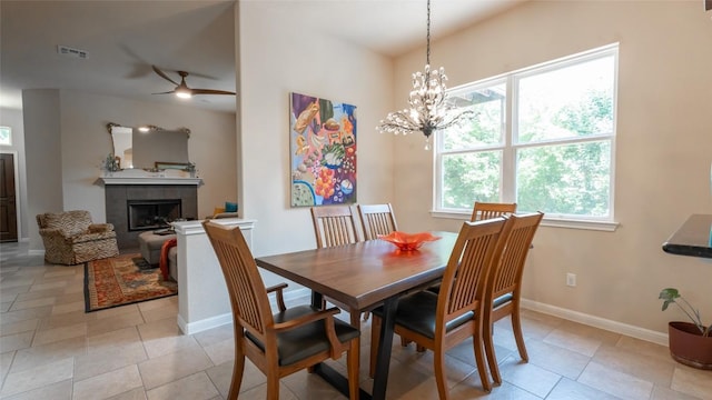 dining area with light tile patterned floors, a tile fireplace, visible vents, and baseboards