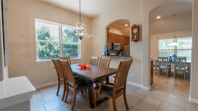 dining area with recessed lighting, light tile patterned floors, baseboards, and an inviting chandelier