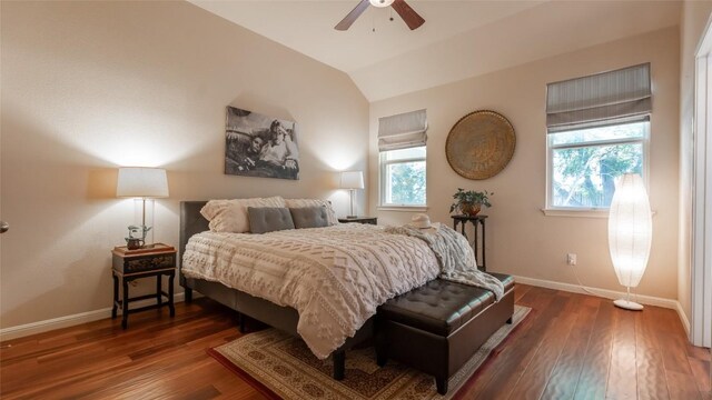 bedroom with vaulted ceiling, dark wood-type flooring, and ceiling fan