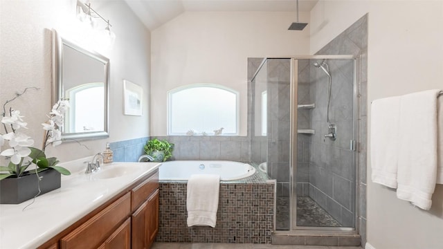 full bath with plenty of natural light, vanity, a bath, and a shower stall