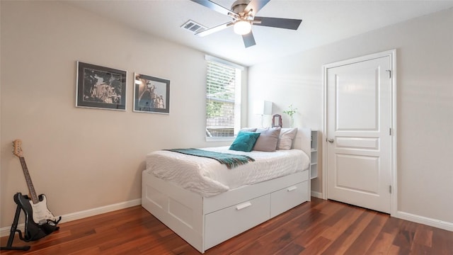 bedroom featuring dark wood finished floors, visible vents, and baseboards