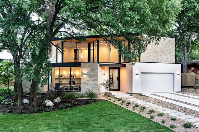 modern home featuring a front lawn and a garage