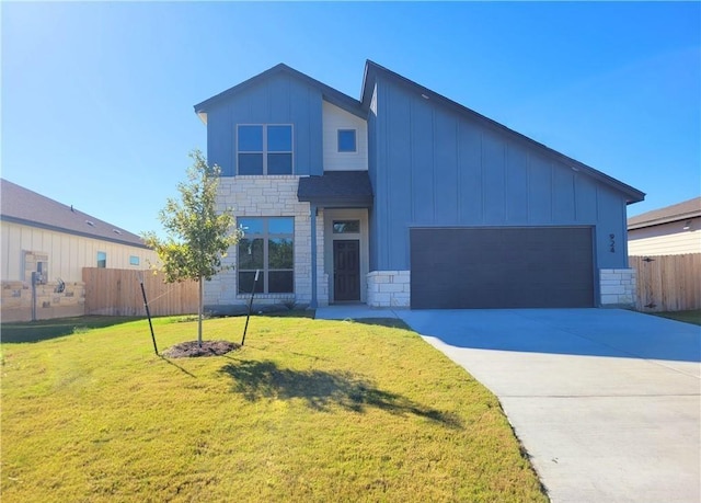 view of front of home featuring a garage and a front yard