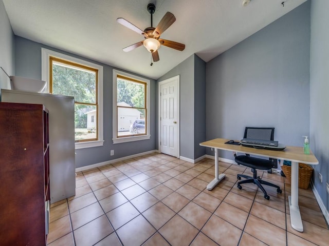 tiled home office featuring vaulted ceiling and ceiling fan