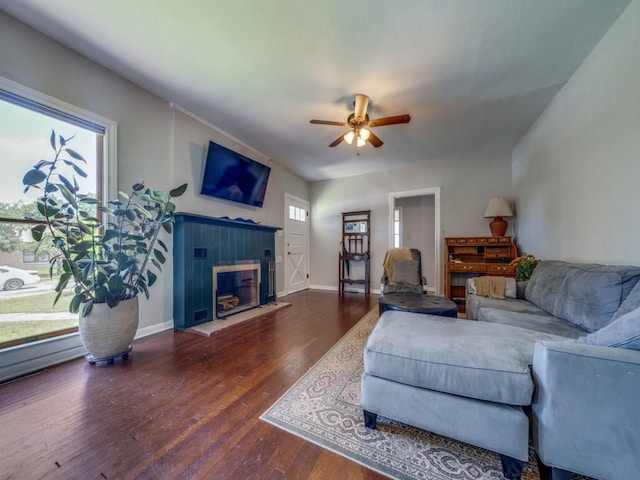 living room featuring dark hardwood / wood-style flooring and ceiling fan