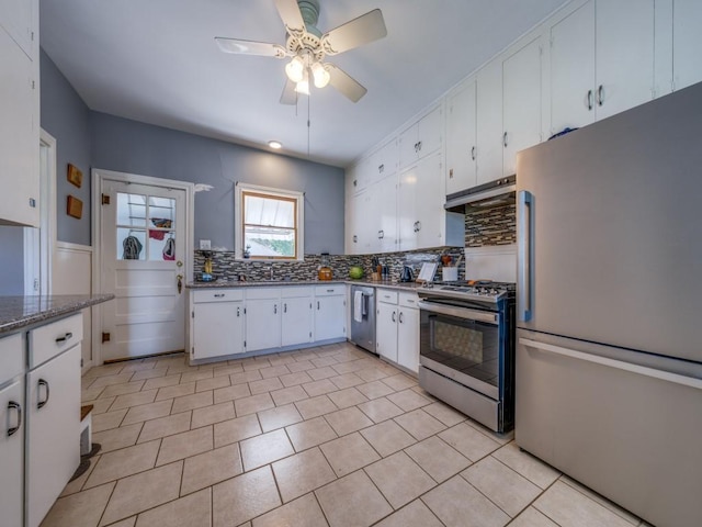 kitchen with ceiling fan, light stone countertops, appliances with stainless steel finishes, tasteful backsplash, and white cabinetry