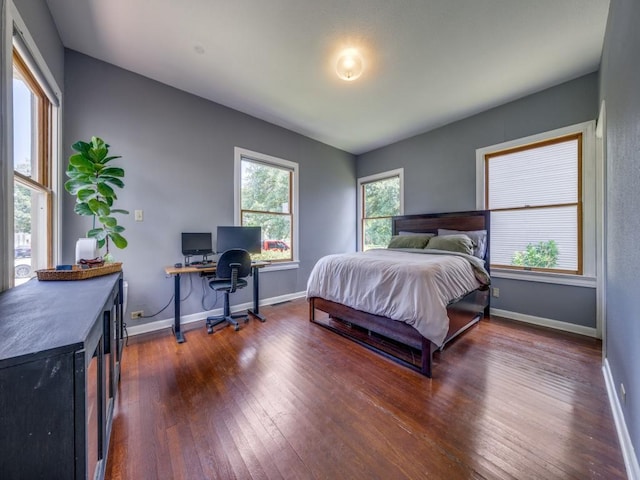 bedroom with dark hardwood / wood-style flooring