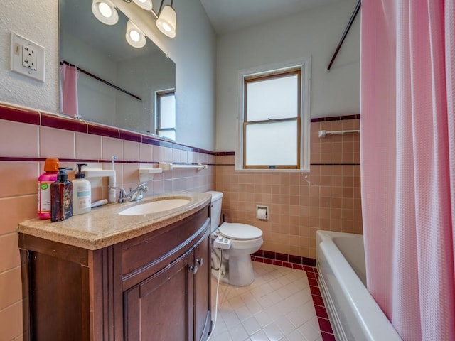 full bathroom with shower / bath combo, tile patterned floors, tile walls, and a healthy amount of sunlight