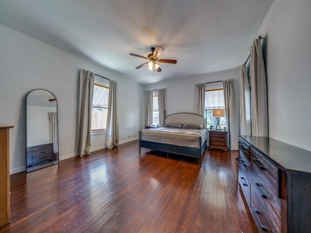 bedroom with dark hardwood / wood-style floors, multiple windows, and ceiling fan