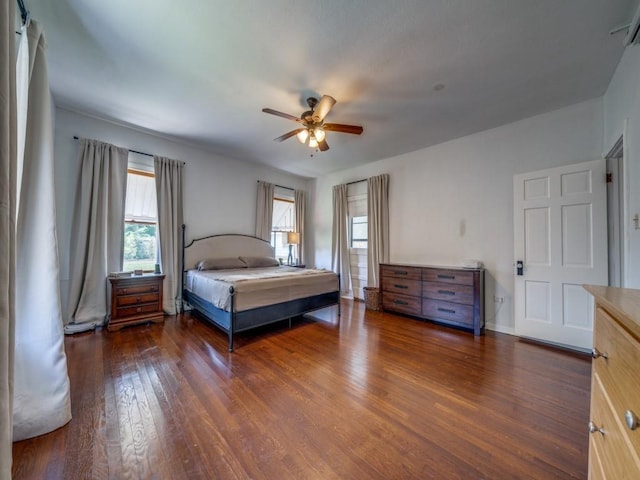 unfurnished bedroom featuring ceiling fan and dark hardwood / wood-style flooring